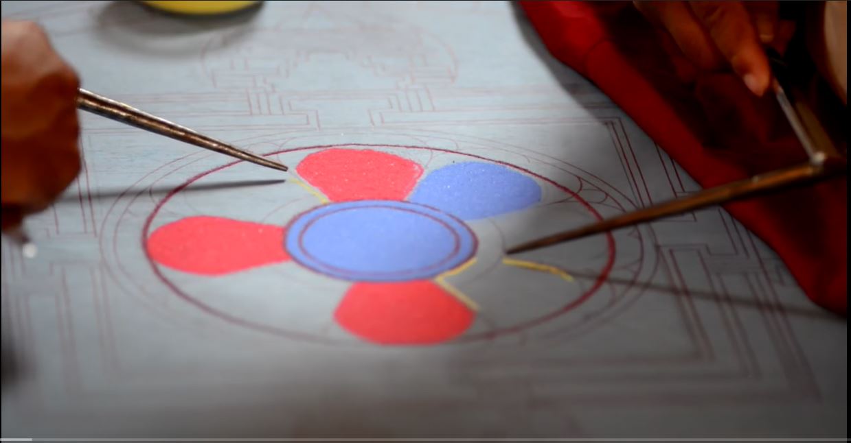 an excerpt from a video of the building of a medicine buddha sand mandala by monks from ngari institute of buddhist dialectics in ladakh india