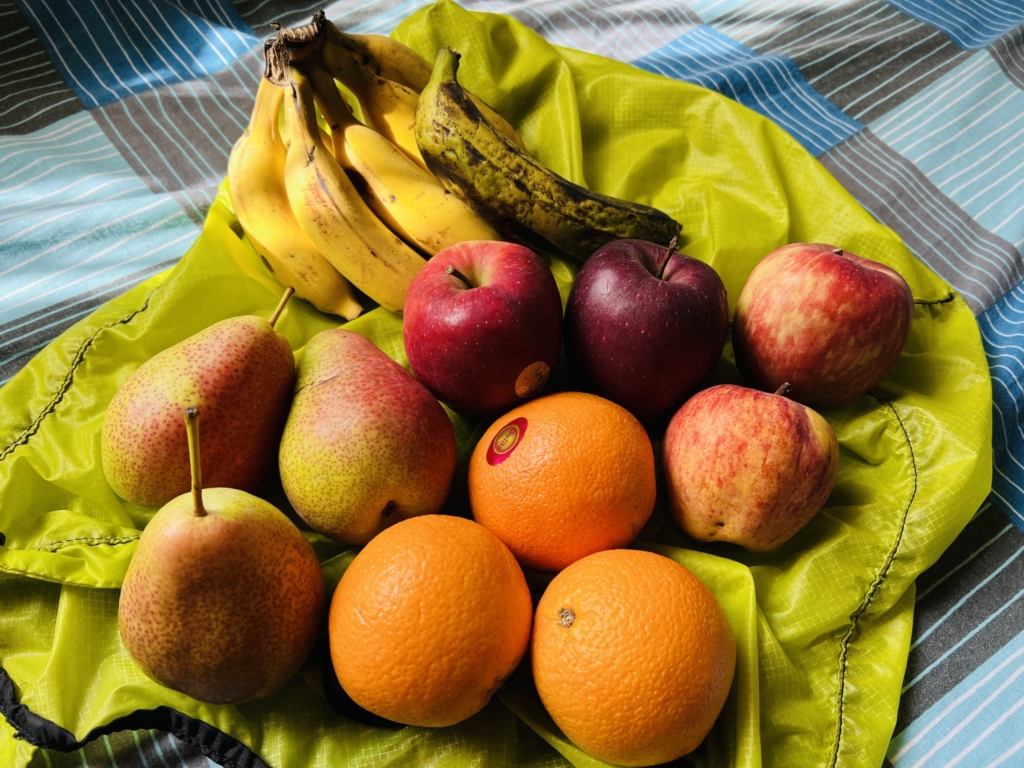 an assortment of fruit on a yellow cloth
