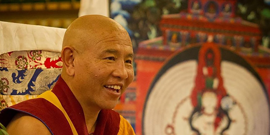 Kyabje Jhado Rinpoche next to an image of 1000 armed chenrezi